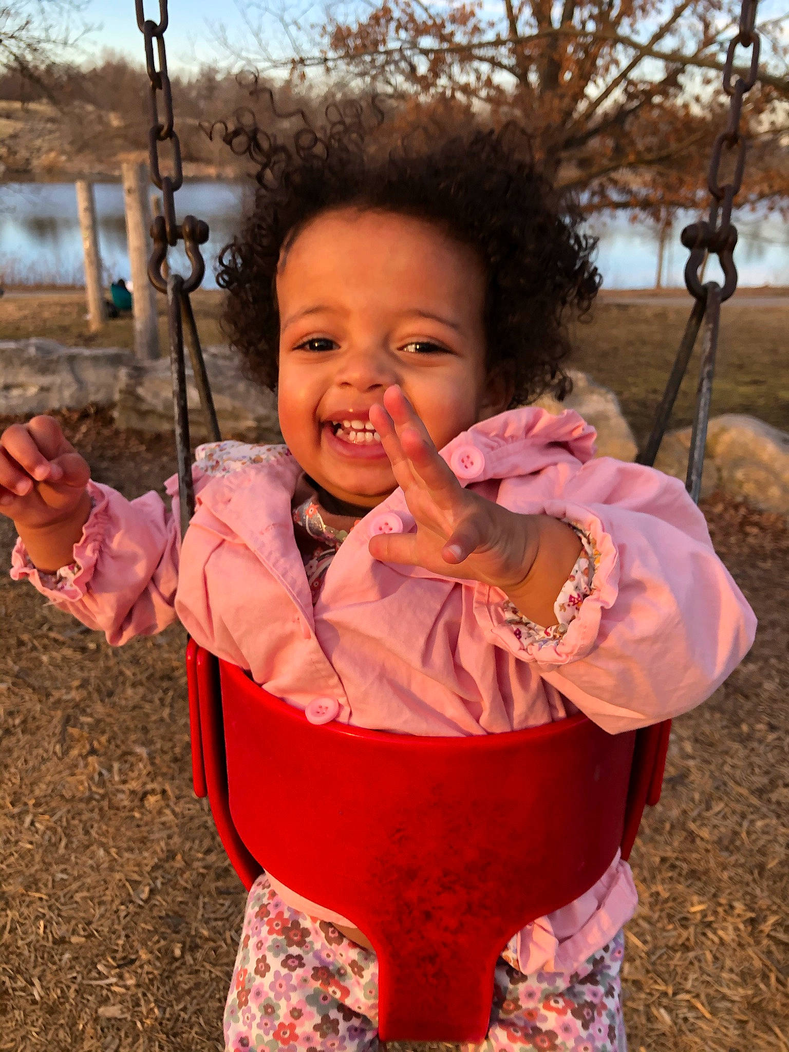 Maliyah joined the competition — help win amazing prizes! eye, face, fun, gesture, grass, happy, leaf, leisure, nose, people_in_nature, person, plant, playground, recreation, skin, sky, smile, swing, toddler, tree