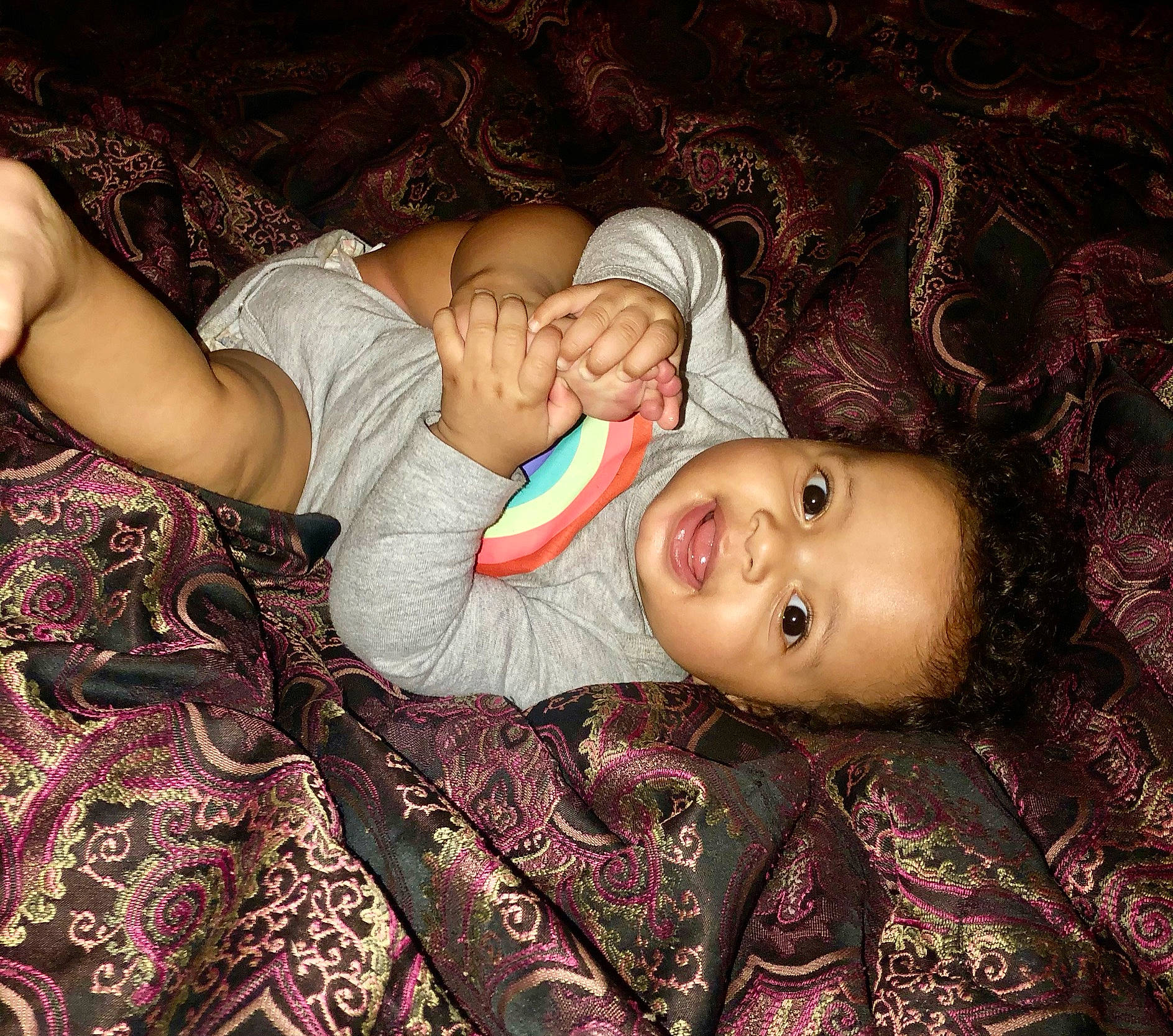 Maliyah is registered to the contest to win money with this photo: baby, baby_toddler_clothing, bed, bedtime, cheek, child, comfort, eye, fun, human_body, iris, linens, nail, pattern, person, pink, room, skin, toddler, vertebrate