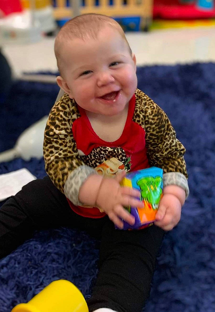 Sophia is registered to the contest to win money with this photo: baby, baby_playing_with_toys, baby_toddler_clothing, cheek, child, comfort, event, finger, fun, hand, happy, head, joy, leisure, person, play, sitting, skin, smile, snapshot