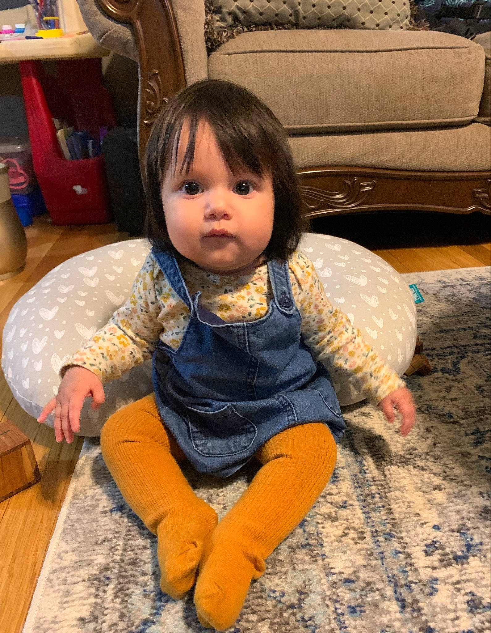 Angela is registered to the contest to win money with this photo: baby_toddler_clothing, cheek, child, comfort, couch, drawer, eye, floor, flooring, foot, fun, happy, head, human_leg, iris, mouth, person, sitting, skin, toddler