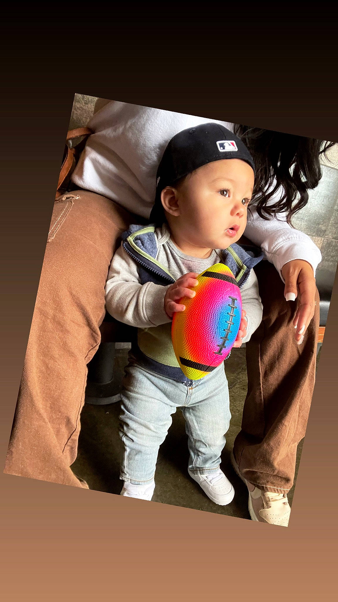 Brodie is registered to the contest to win money with this photo: baby, baby_toddler_clothing, ball, cap, child, cool, facial_expression, flash_photography, fun, gesture, hand, happy, headgear, headwear, human_body, person, shoe, sleeve, sneakers, sports_equipment