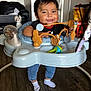 Valentino is registered to the contest to win money with this photo: baby, infant, walker, toy, smiling, indoor, floor, socks, clothing, person, face, happy, child, furniture, living_room, wooden_floor, cute, play, home, young