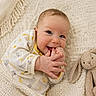 baby, infant, smiling, hand, blanket, knit, plush_toy, bunny, cute, cozy, lying_down, soft_toy, child, newborn, warm, happy, face, apparel, indoors, cute_expression