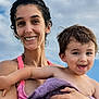 woman, child, toddler, smile, happy, holding, towel, outdoor, sky, clouds, portrait, people, hair, skin, expression, summer, daylight, bare_shoulders, closeup, family