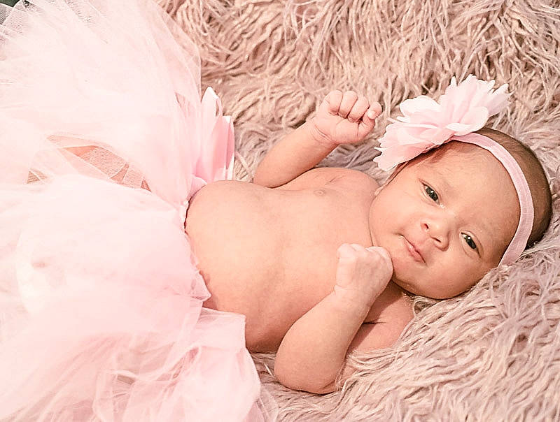 Maria is registered to the contest to win money with this photo: baby, baby_products, baby_sleeping, baby_toddler_clothing, beauty, child, child_model, fashion_accessory, fur, hair_accessory, headband, headgear, headpiece, headwear, person, photograph, photography, pink, portrait_photography, product