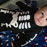 Atreus joined the competition — help win amazing prizes! baby, infant, onesie, skeleton_costume, black_clothing, blanket, blue_blanket, candy_cane_pattern, snowflake_pattern, indoor, floor, carpet, person, face, head, cute, lying_down, child, young, costume