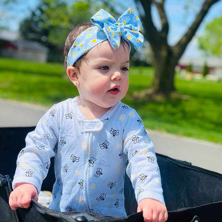Enaís joined the competition — help win amazing prizes! accessories, baby, bandana, clothing, face, formalwear, furniture, grass, head, headband, pants, person, photography, plant, portrait, sitting, sleeve, sunglasses, tie, walking