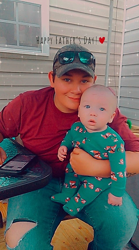 Tobias is registered to the contest to win money with this photo: baby, baby_toddler_clothing, baseball_cap, cap, child, cool, event, facial_expression, fun, green, hairstyle, happy, headgear, headwear, holiday, joy, lap, leisure, person, smile