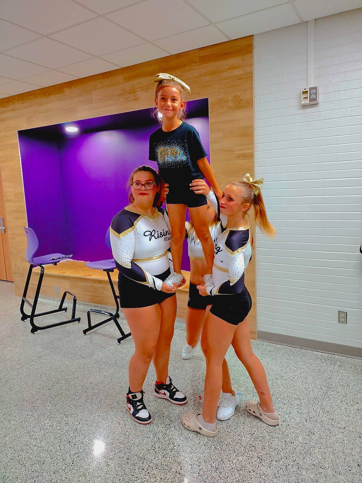 Payten is registered to the contest to win money with this photo: chair, cheerleading_uniform, choreography, competition_event, dance, electric_blue, entertainment, event, human_leg, joy, knee, leisure, performing_arts, person, recreation, shorts, smile, sports, sports_uniform, sportswear