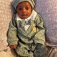 Taylen joined the competition — help win amazing prizes! baby, child, knitwear, green_outfit, hat, bow_tie, blanket, star_pattern, infant, cute, portrait, sitting, cozy, soft_texture, hand, feet, sleepwear, indoors, young_child, face