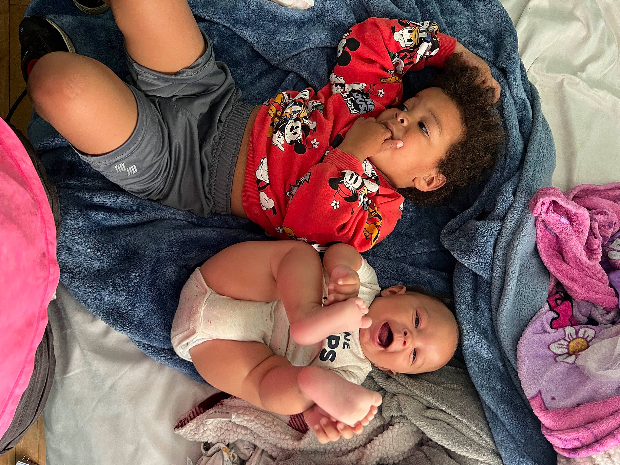 Kaiden is registered to the contest to win money with this photo: baby, baby_toddler_clothing, cheek, child, comfort, dress, event, finger, hand, happy, headgear, human_body, interaction, lip, pattern, person, pink, skin, textile, thigh