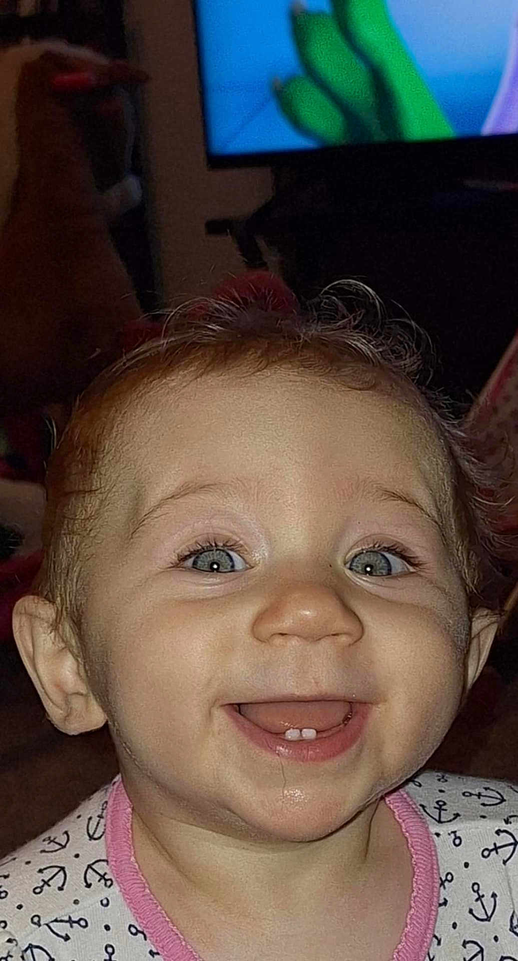 Cora joined the competition — help win amazing prizes! baby, child, smiling, teeth, face, eyes, clothing, indoors, television, happy, cute, infant, expression, portrait, person, head, hair, pink, pattern, closeup
