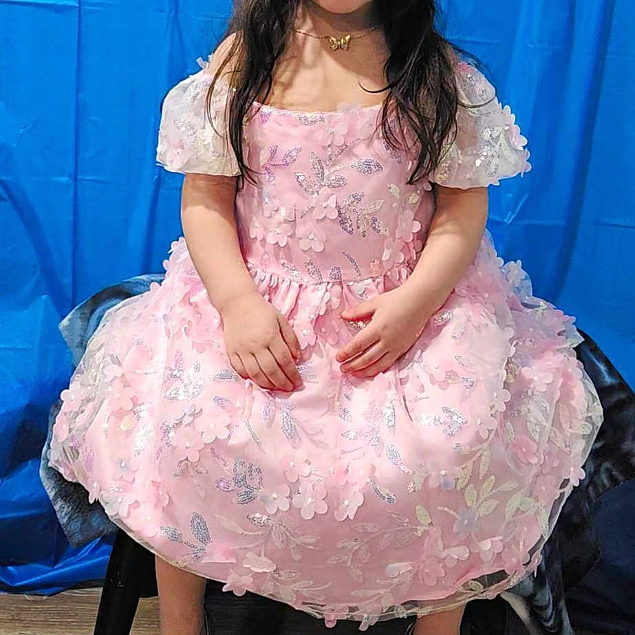 Athena is registered to the contest to win money with this photo: blackhair, child, clothing, dress, eveningdress, face, female, footwear, formalwear, girl, hair, happy, head, highheel, person, sandal, shoe, sitting, sleeve, standing