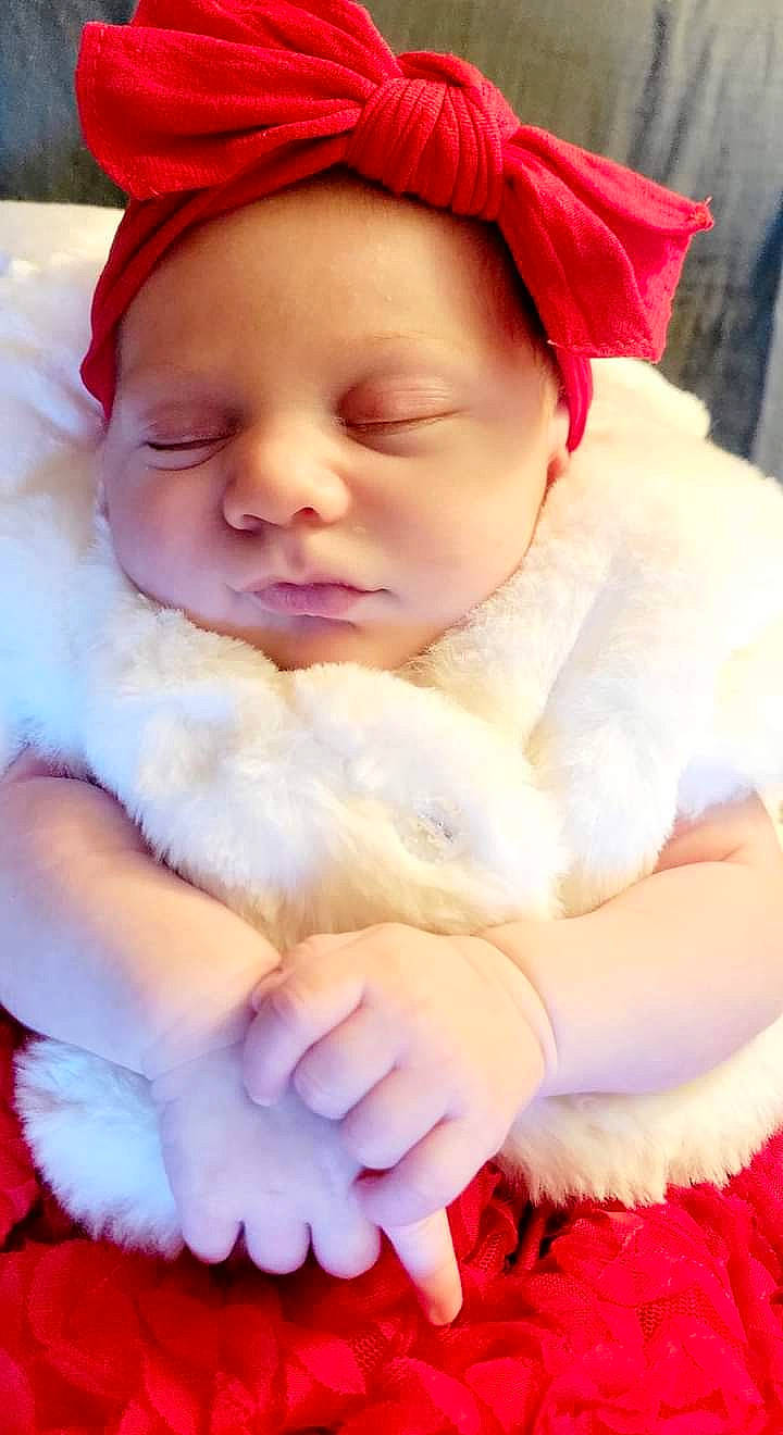 Elora is registered to the contest to win money with this photo: baby, baby_toddler_clothing, cap, cheek, comfort, face, finger, gesture, grass, happy, hat, headwear, lip, person, pink, red, skin, sleeve, textile, thumb