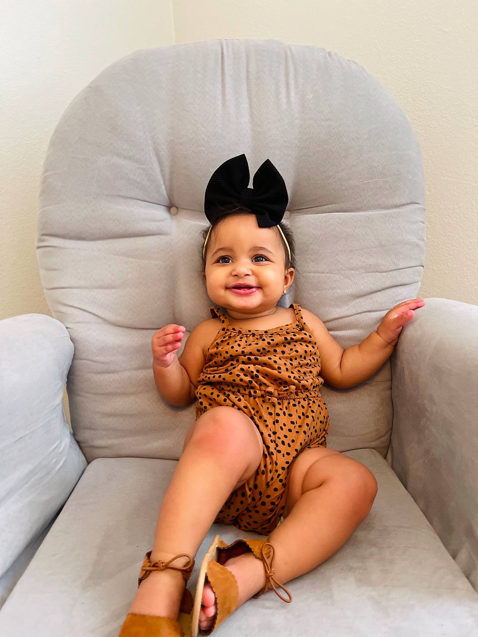 Lillie is registered to the contest to win money with this photo: arm, baby_toddler_clothing, cap, clothing, comfort, couch, eye, face, hair, hat, head, human_body, joy, knee, leg, neck, person, skin, sleeve, smile
