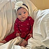 Paris joined the competition — help win amazing prizes! baby, infant, child, red_clothing, headband, flower, blanket, white_blanket, indoor, cute, portrait, sitting, soft, cozy, person, young_child, face, looking_away, hands, feet
