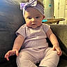 Paris joined the competition — help win amazing prizes! baby, infant, child, headband, purple_clothing, sitting, couch, indoor, curious, reaching_hand, cozy, soft_lighting, furniture, modern_appliance, home_interior, portrait, cute, small_hands, expression, comfortable