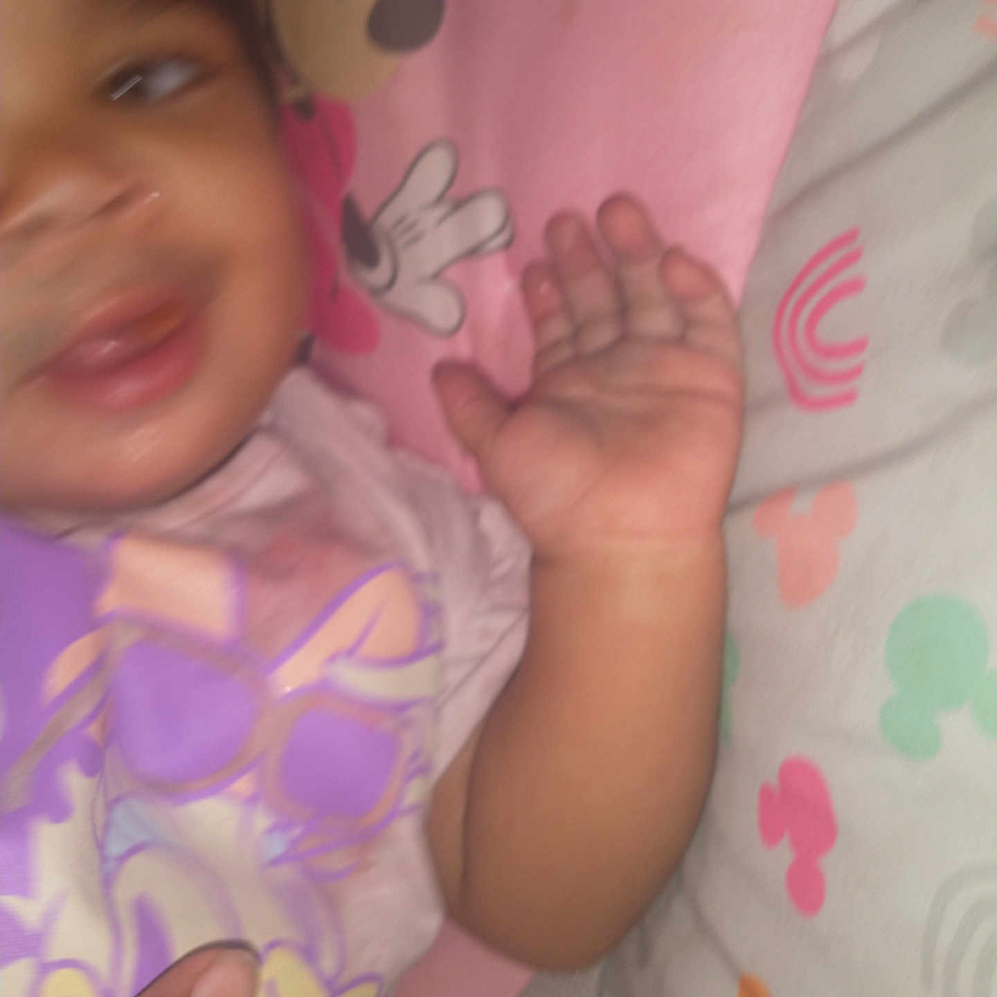 Taylonna is registered to the contest to win money with this photo: baby, bed, bedding, blur, cartoon, child, clothing, colorful, fabric, hand, indoor, infant, pattern, person, pink, playful, purple, skin, smile, toddler