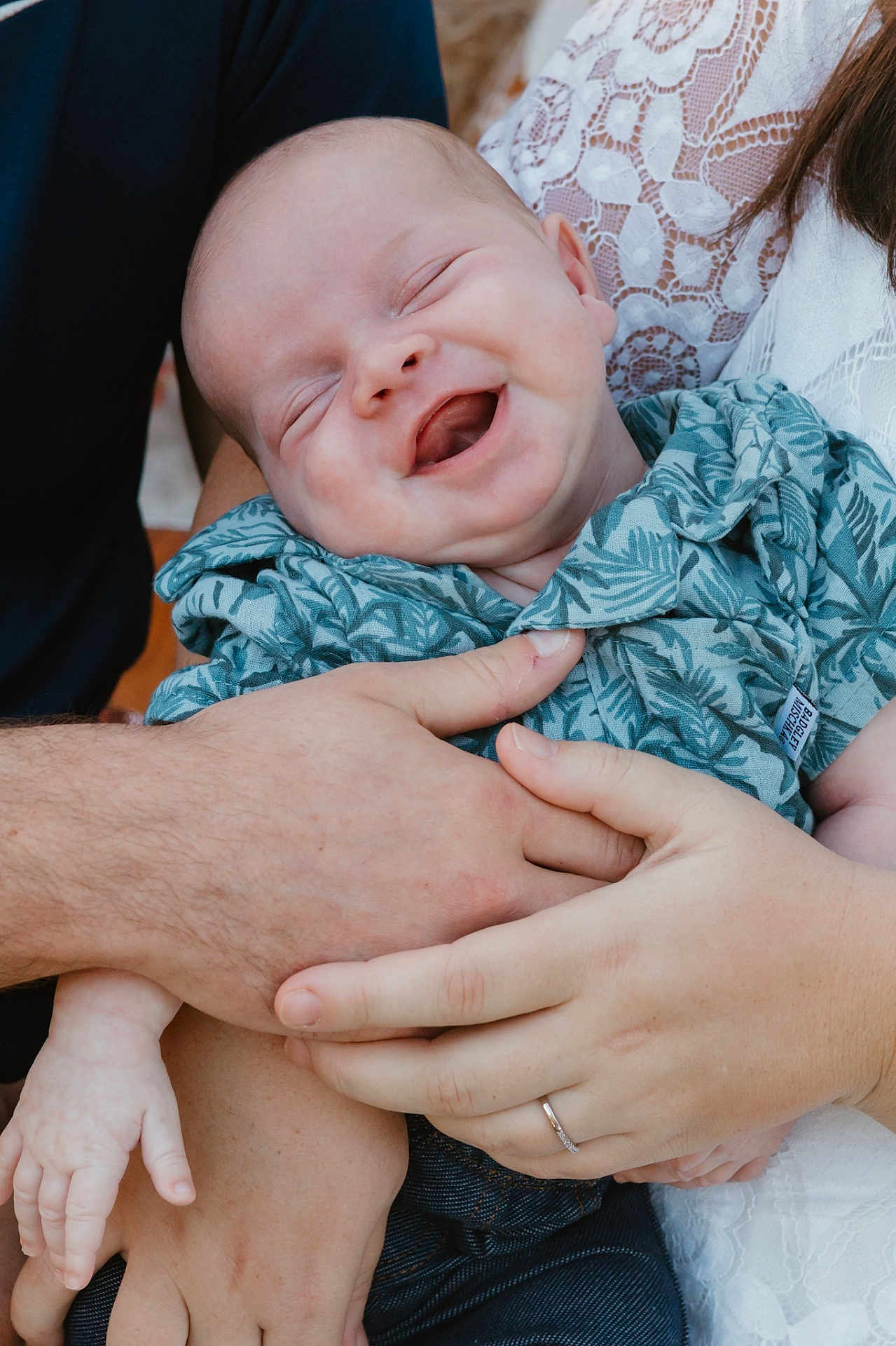 Christopher is registered to the contest to win money with this photo: baby, smiling, happy, child, hands, holding, clothing, patterned_shirt, adult, love, closeup, portrait, infant, family, skin, lace, jeans, person, outdoor, tenderness
