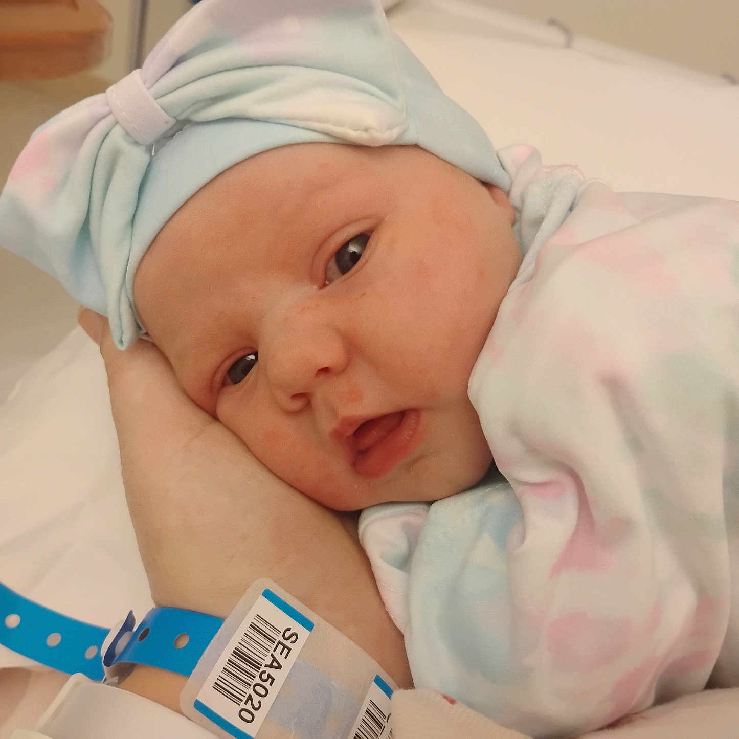 Alina joined the competition — help win amazing prizes! newborn, baby, infant, hand, hospital_wristband, blanket, hat, bow, face, sleepy, resting, wrapped, pastel_colors, closeup, indoors, person, skin, cute, soft, hospital