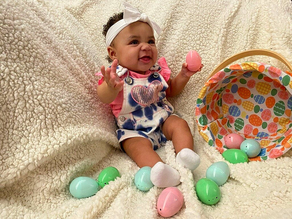 Monay is registered to the contest to win money with this photo: baby, baby_products, baby_toddler_clothing, child, comfort, easter, event, face, fun, happy, headwear, holiday, linens, pattern, person, play, sitting, smile, sock, t_shirt