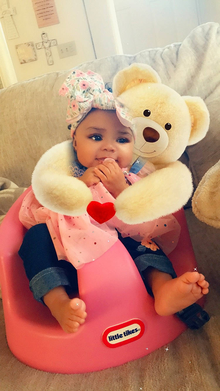 Monay is registered to the contest to win money with this photo: baby, baby_products, baby_sleeping, baby_toys, child, comfort, event, fun, gesture, happy, headwear, interaction, person, pink, plush, red, skin, stuffed_toy, teddy_bear, textile