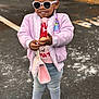 Nia joined the competition — help win amazing prizes! child, toddler, sunglasses, pink_jacket, jeans, pink_crocs, handbag, smile, standing, outdoor, asphalt, parking_lot, brick_wall, bow_hair, pearls, fashion, portrait, cute, playful, accessories