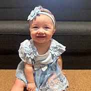Naomi joined the competition — help win amazing prizes! baby, child, smiling, blue_dress, headband, lace, carpet, couch, indoor, cute, happy, sitting, portrait, infant, person, young_child, baby_girl, apparel, fashion, adorable