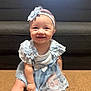 baby, child, smiling, blue_dress, headband, lace, carpet, couch, indoor, cute, happy, sitting, portrait, infant, person, young_child, baby_girl, apparel, fashion, adorable