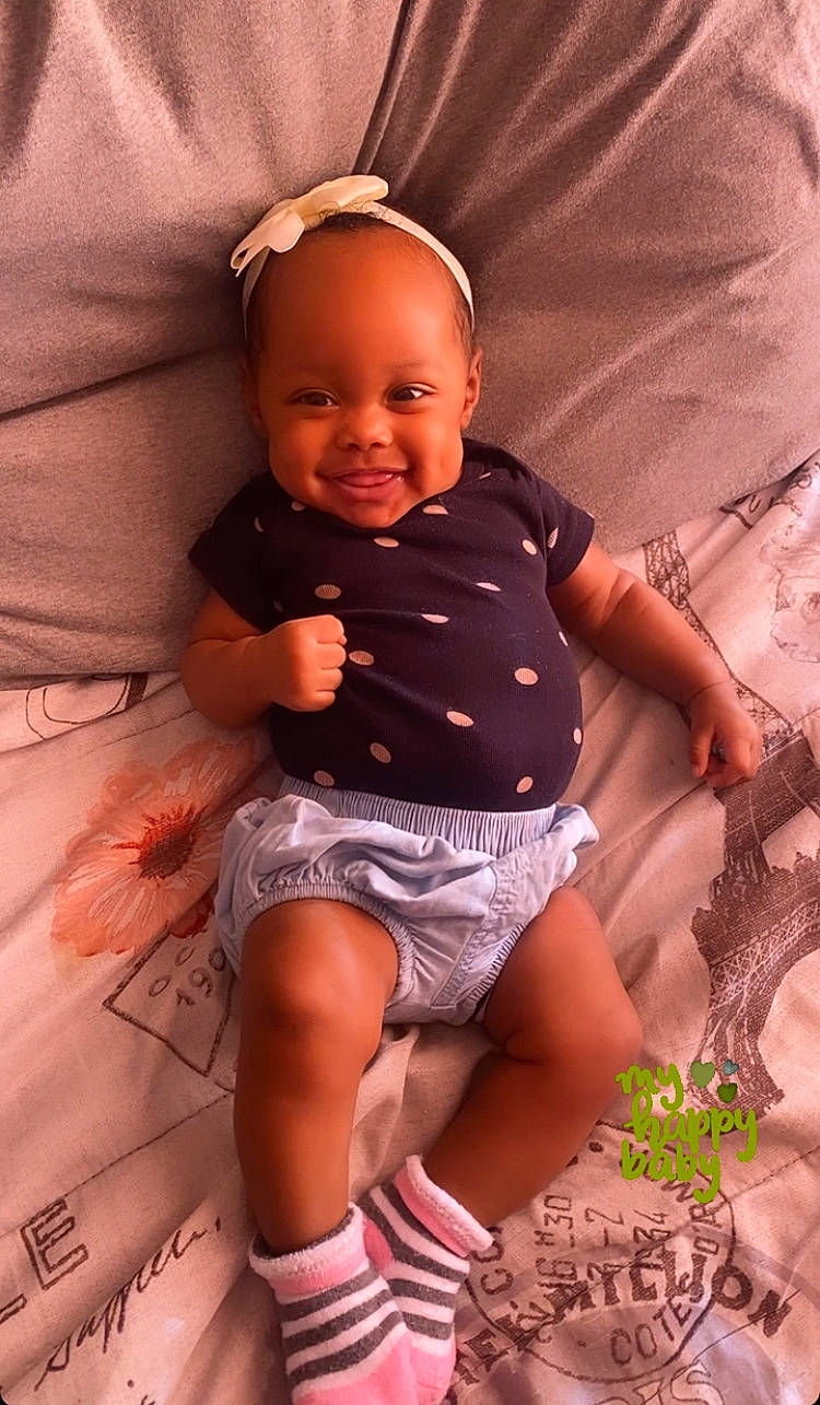 Honesty is registered to the contest to win money with this photo: arm, baby, baby_toddler_clothing, face, facial_expression, finger, hairstyle, head, human, human_body, joy, leg, lip, mouth, muscle, organ, person, pink, skin, smile