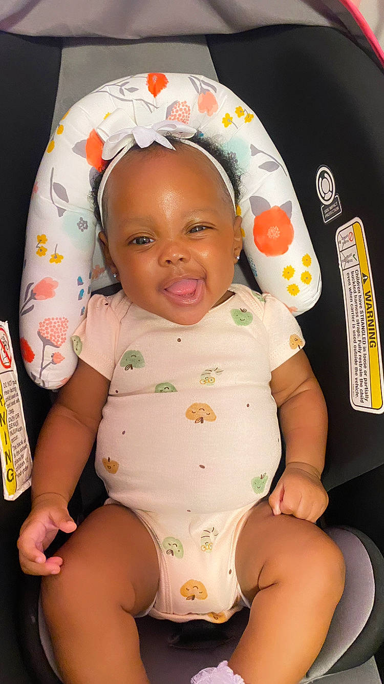 Honesty is registered to the contest to win money with this photo: baby, baby_toddler_clothing, cheek, child, chin, comfort, eye, face, facial_expression, happy, human, joy, mouth, orange, person, product, skin, sleeve, smile, stomach