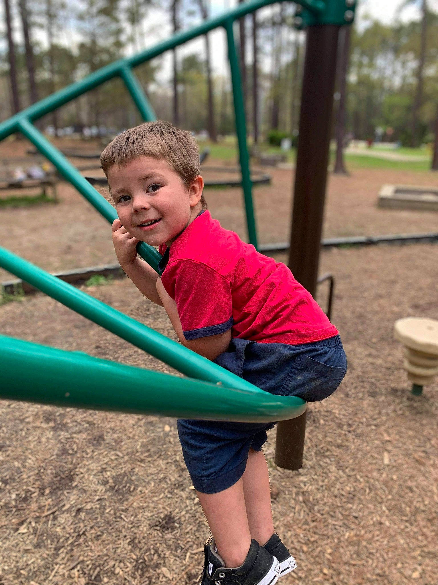 John Keith is registered to the contest to win money with this photo: child, city, fun, grass, happy, joy, leisure, outdoor_play_equipment, outdoor_recreation, people_in_nature, person, plant, play, playground, recreation, shorts, sitting, smile, soil, t_shirt
