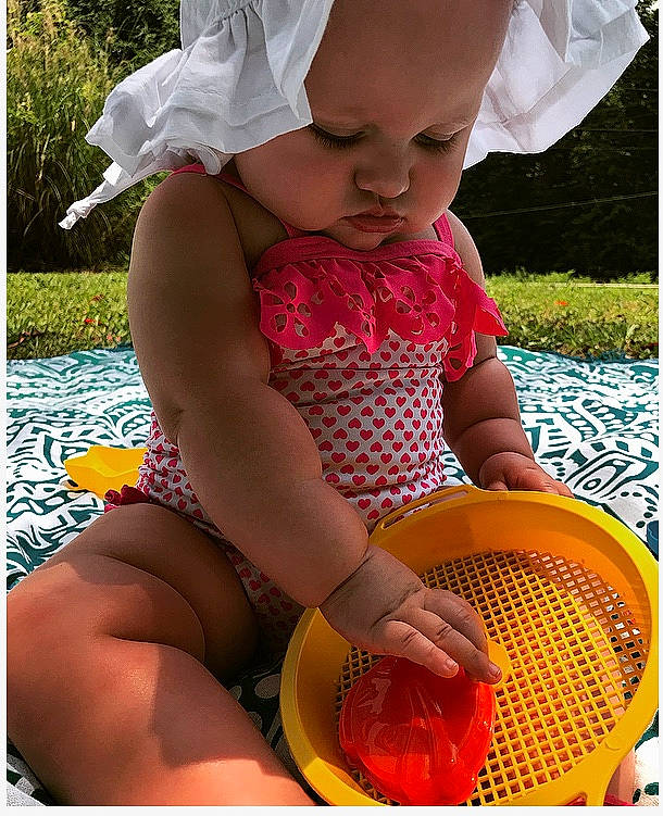 Hadlee is registered to the contest to win money with this photo: baby, baby_toddler_clothing, beauty, child, face, fun, grass, happy, headwear, leisure, light, people_in_nature, person, photograph, pink, plant, skin, summer, sun_hat, thigh