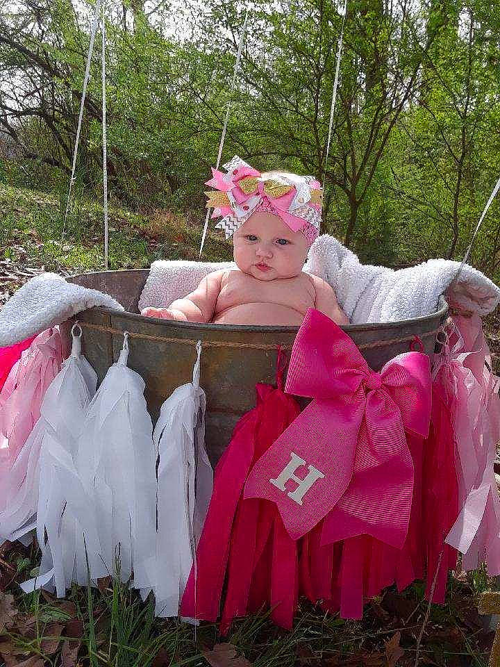 Hadlee joined the competition — help win amazing prizes! baby_toddler_clothing, botany, chair, child, event, fun, garden, grass, happy, headwear, lawn, leisure, magenta, people_in_nature, person, pink, plant, recreation, sitting, textile