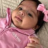 Layla is registered to the contest to win money with this photo: adidas, apparel, baby, bow, child, clothing, cute, expression, eyes, face, hair, hand, indoor, infant, lying_down, pink_jacket, portrait, quilted_bedspread, skin, young
