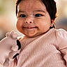 Layla joined the competition — help win amazing prizes! baby, child, cute, smiling, face, portrait, pink_clothing, soft_toy, indoor, closeup, happy, infant, young_child, person, warm_light, head, ears, black_hair, skin, adorable