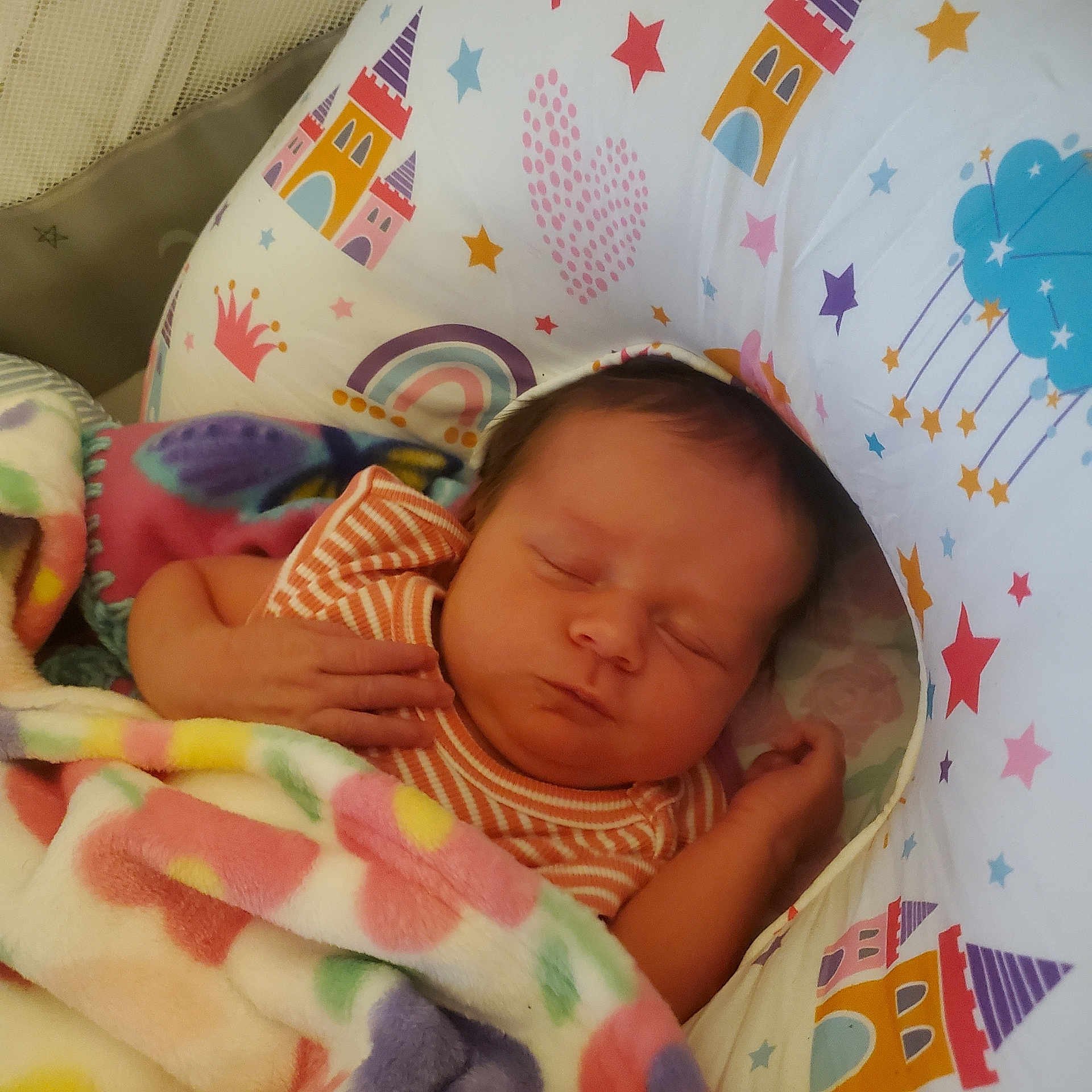 Sophia is registered to the contest to win money with this photo: newborn, baby, sleeping, infant, face, portrait, bassinet, blanket, swaddle, crib, nursery, rainbow, castle, stars, pastel, striped_clothing, cozy, indoors, hand, peaceful