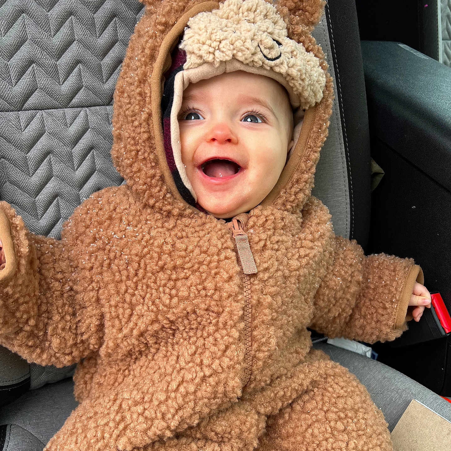 Scarlett is registered to the contest to win money with this photo: accessories, baby, babylaughing, bag, cap, clothing, coat, face, handbag, happy, hat, head, hood, jacket, knitwear, laughing, person, photography, portrait, sweater