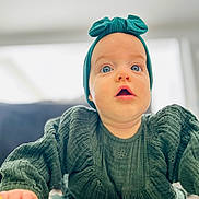 Lexie participe au concours pour gagner de l'argent avec cette photo : baby, blue_eyes, child, close_up, clothing, crawling, curious, cute, expression, face, floor, green_clothing, headband, indoor, infant, person, portrait, soft_focus, tummy_time, young_child
