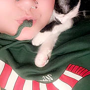 Mustache joined the competition — help win amazing prizes! black_and_white_cat, casual_clothing, cat, close_up, comfort, cuddle, cute, drawstring, eyewear, face, glasses, hoodie, indoor, nose_piercing, person, pet, playful, portrait, resting_cat, young_adult