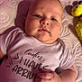 Konrad is registered to the contest to win money with this photo: baby, infant, onesie, text_on_clothing, plush_toy, bee_toy, blanket, texture, hand, face, cute, chubby_cheeks, lying_down, soft_lighting, indoor, child, newborn, portrait, closeup, clothing