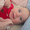 baby, infant, child, portrait, smiling, wide_eyed, lying_down, red_outfit, blanket, pink_blanket, blue_blanket, bedding, cozy, indoors, face, eyes, happy, candid, close_up, photography
