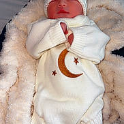 Cory joined the competition — help win amazing prizes! newborn, baby, sleeping, knit_hat, knit_outfit, moon, stars, blanket, cozy, soft, white, cream, infant, cute, warm, sleep, person, clothing, footwear, hospital_band