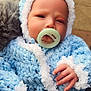 Cory joined the competition — help win amazing prizes! baby, pacifier, knitwear, blue, white, hand, face, infant, cute, outdoor, winter_clothing, warm, hood, portrait, child, soft_texture, closeup, skin, expression, person