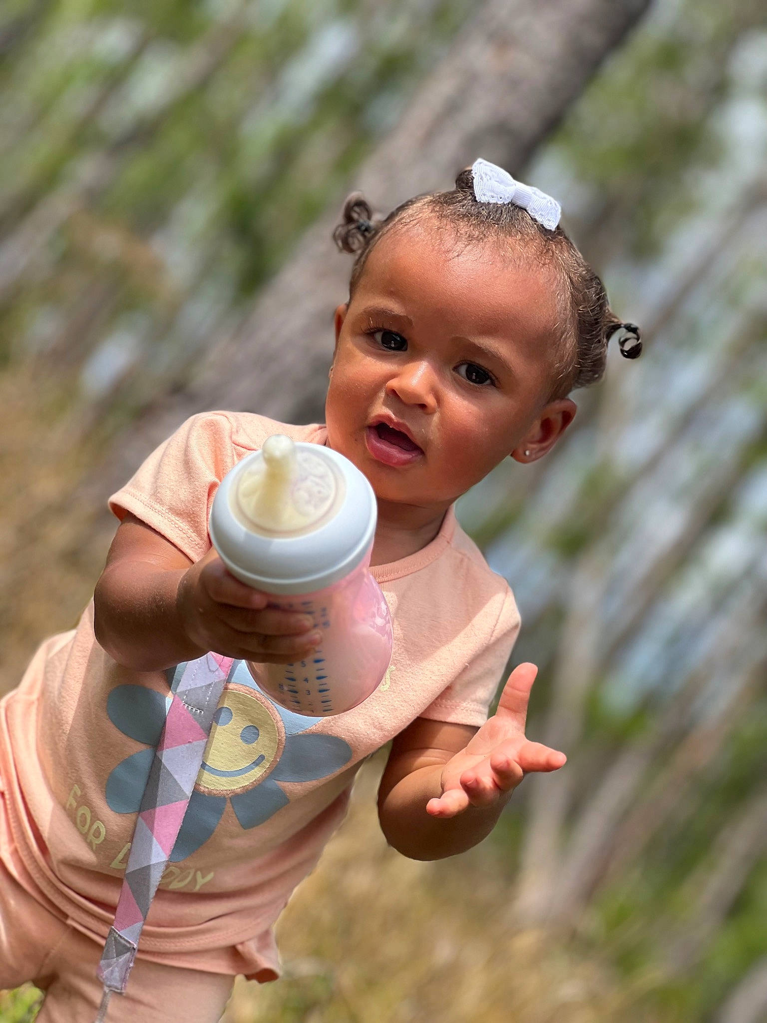 Cayleigh is registered to the contest to win money with this photo: child, drinkware, finger, flash_photography, fun, gesture, grass, hand, happy, head, leisure, liquid_bubble, people, people_in_nature, person, soil, t_shirt, toddler, tree, vacation