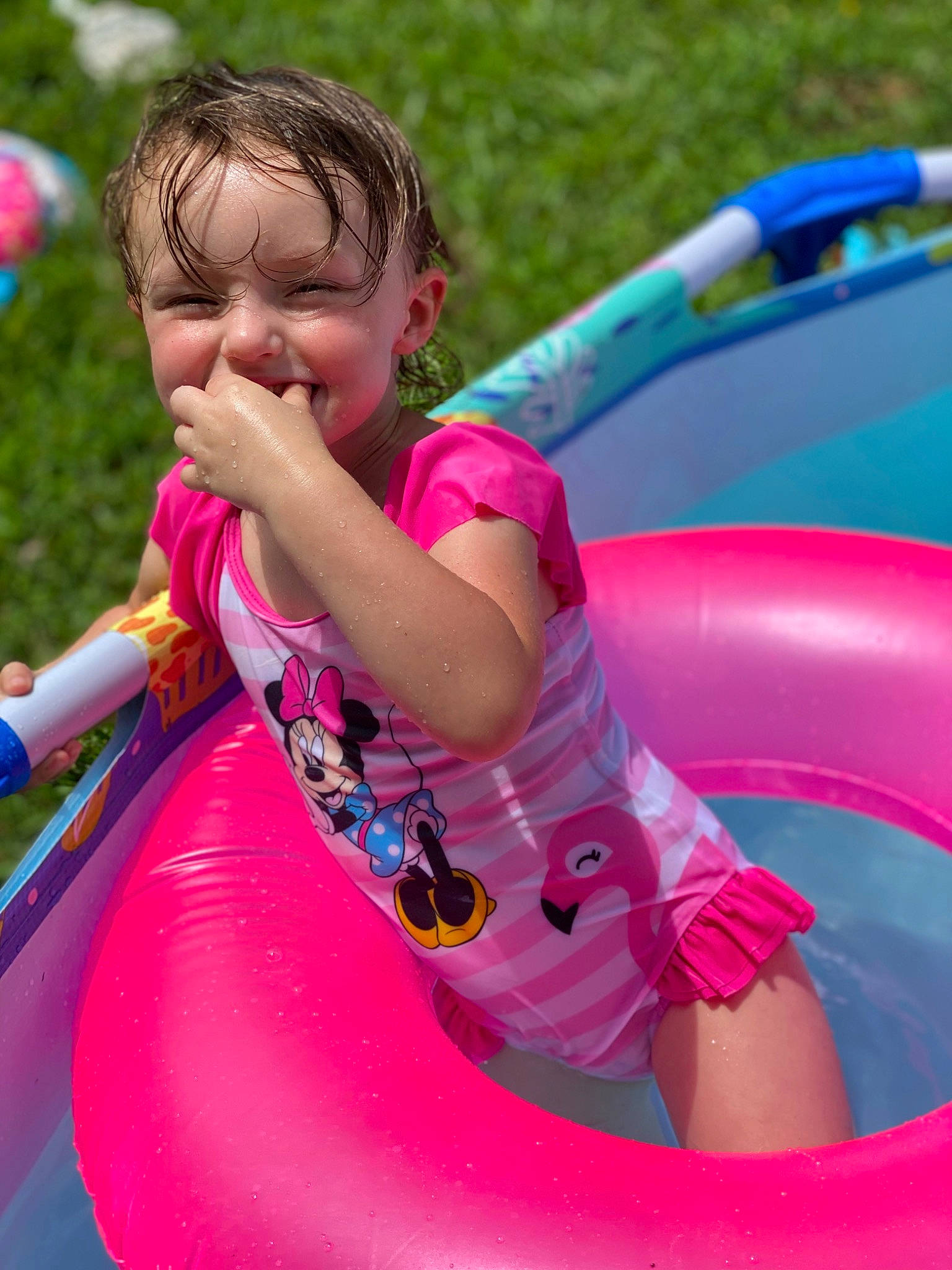 Rosalie joined the competition — help win amazing prizes! baby_toddler_clothing, blue, boats_and_boating_equipment_and_supplies, child, chute, fun, grass, happy, inflatable, leisure, magenta, outdoor_play_equipment, person, photograph, pink, play, playground, recreation, summer, toddler