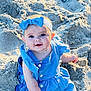 baby, child, blue_dress, headband, bow, sand, beach, smile, face, cute, sunlight, outdoor, sitting, happy, infant, person, skin, eyes, portrait, summer
