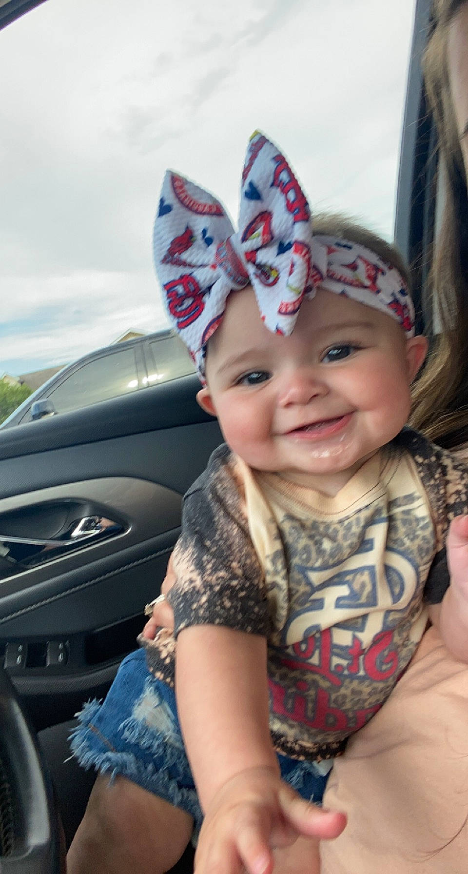 Annslee is registered to the contest to win money with this photo: automotive_design, automotive_exterior, baby, bumper, cap, costume_hat, eye, eyewear, fun, happy, hat, headwear, hood, joy, motor_vehicle, person, personal_luxury_car, sky, smile, sun_hat