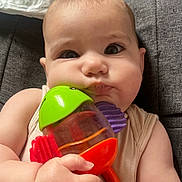 Lylou participe au concours pour gagner de l'argent avec cette photo : baby, child, toy, colorful, holding, face, arms, diaper, sitting, indoor, closeup, cute, infant, expression, skin, fingers, head, clothing, play, background