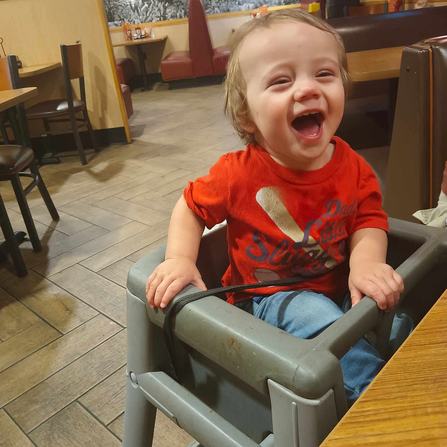 Lorenzo is registered to the contest to win money with this photo: baby, bodypart, chair, couch, diningtable, face, finger, furniture, happy, hardwood, head, indoors, person, photography, plywood, portrait, restaurant, sitting, table, wood
